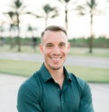 a-man-in-a-green-shirt-is-posing-for-a-picture.jpg a man in a green shirt is posing for a picture